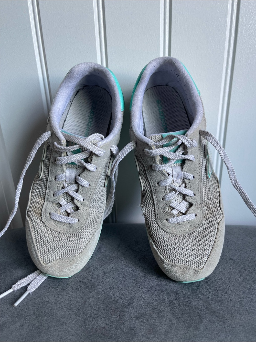 New Balance 515 sneakers in a light gray color with turquoise accents